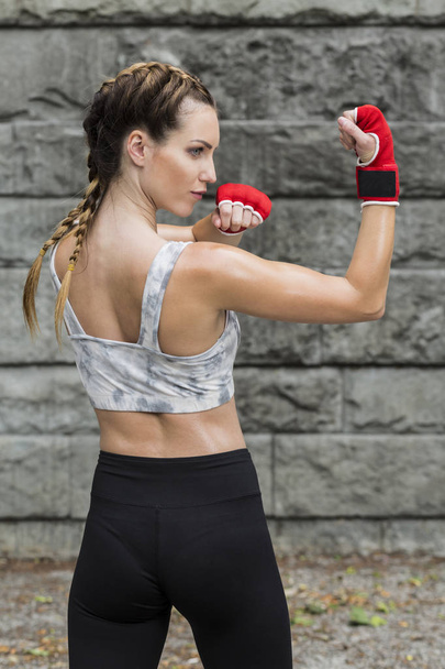 Sporty woman in a gym gloves - Foto, Imagen