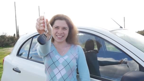 Mujer joven mostrando la llave de un coche nuevo
 - Imágenes, Vídeo