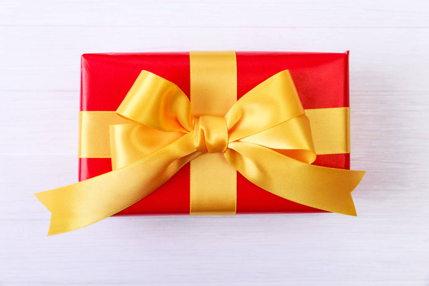 Gift box with yellow bow. Red present package. - Foto, imagen