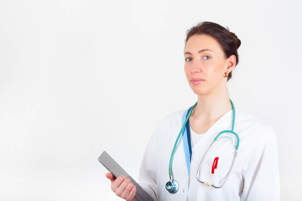 Portret van de jonge aantrekkelijke dokter, chirurg, nurse met stethos - Foto, afbeelding