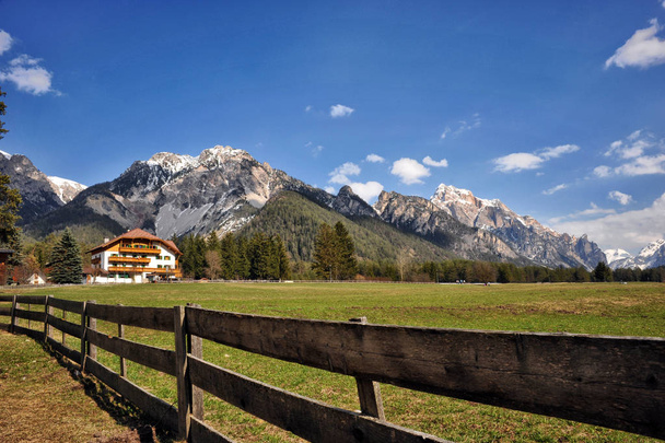 Landscape of Dolomites mountains in summer with a farm and meadow - Photo, Image