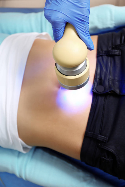 Young woman undergoing laser treatment in modern clinic, closeup - Photo, Image