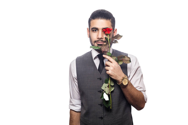 Handsome romantic happy man with rose flower.  - 写真・画像