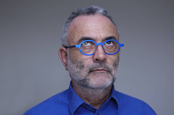 middle-aged man with blue shirt and glasses - Photo, Image