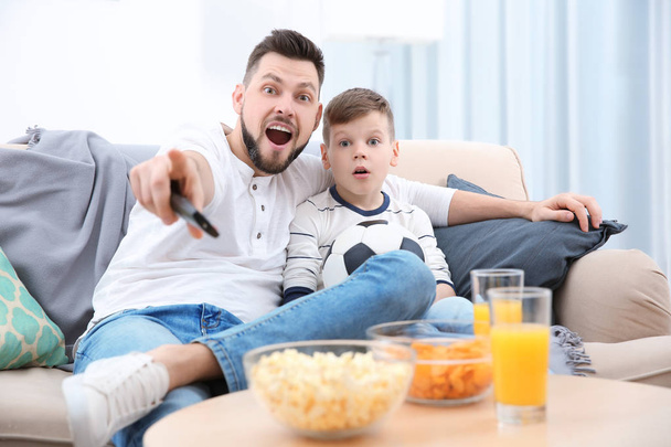 父と息子の自宅のテレビでサッカーを見て - 写真・画像