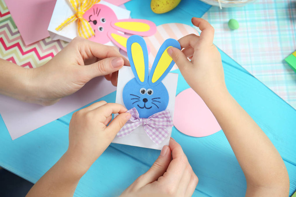 Mother and daughter holding handmade Easter gift box - Фото, зображення