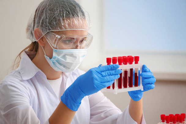 Woman working with blood samples in laboratory - Fotografie, Obrázek