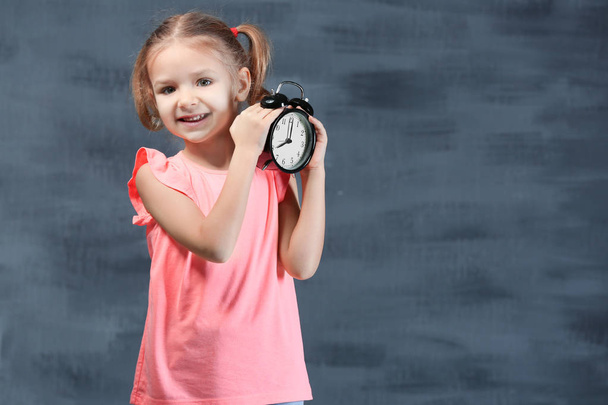 little girl with alarm clock  - Foto, imagen