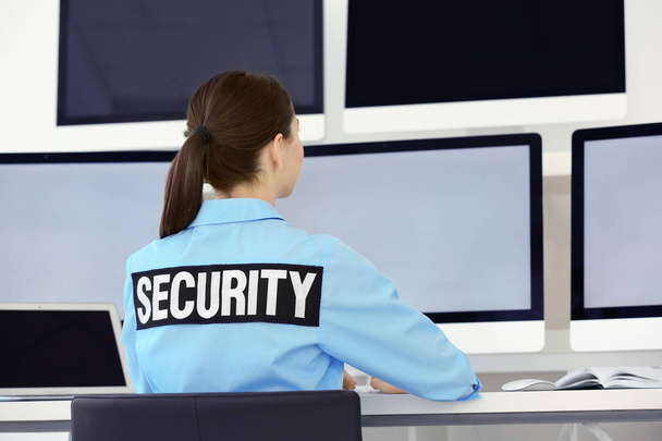 Beautiful security guard in surveillance room - Photo, Image