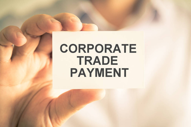 Businessman holding CTP CORPORATE TRADE PAYMENT message card - Photo, Image