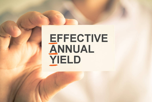 Businessman holding card with EAY EFFECTIVE ANNUAL YIELD acronym text - Photo, Image