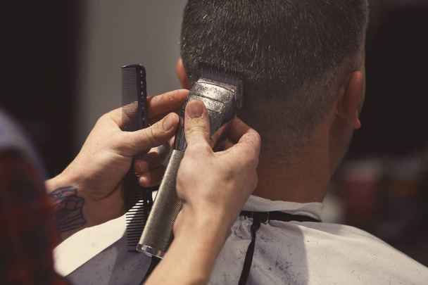 Barber making modern male hairstyle - Photo, Image