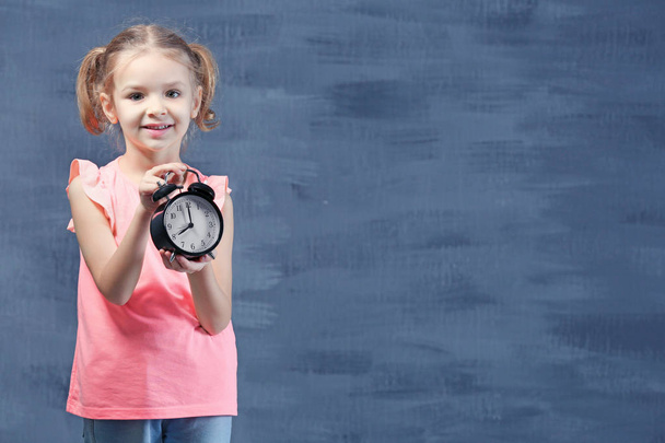 little girl with alarm clock  - Foto, Imagen