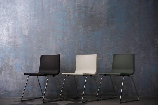 Chairs near grey wall  - Foto, imagen