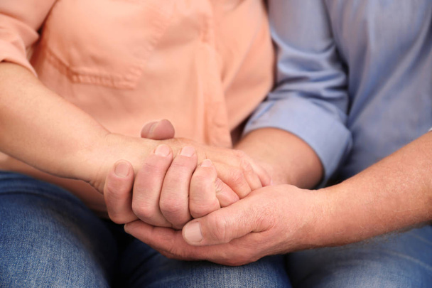 Closeup of husband holding wife's hand - Foto, Bild