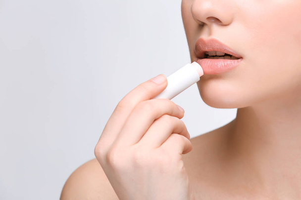 Woman applying lip balm - Fotó, kép