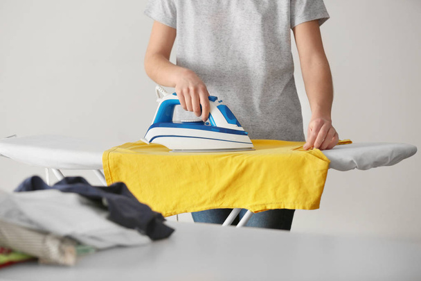Woman ironing cloth - Fotoğraf, Görsel