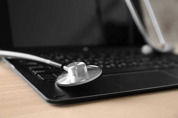 Modern laptop and stethoscope - Фото, зображення