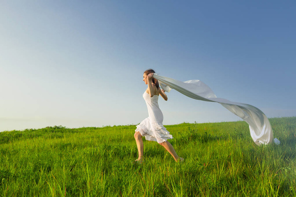 woman running through the meadow - Fotó, kép