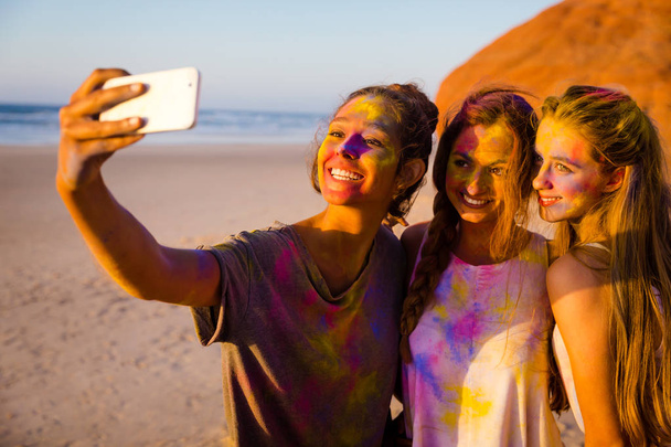 Young girls in colored powder - Photo, image