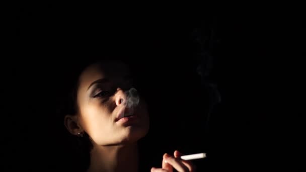 Sexy woman exhailing a stream of smoke - Filmati, video
