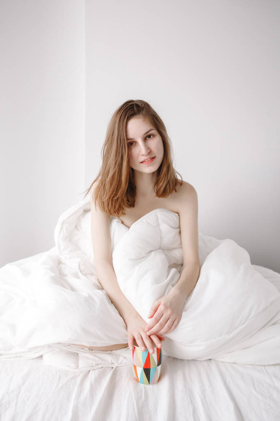 woman sitting on bed - Photo, Image