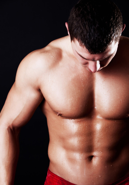 Athlete showing his abdominal muscles - Valokuva, kuva
