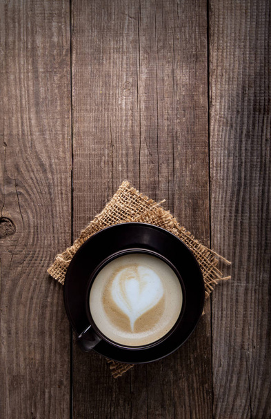 cup of cappuccino coffee on old vintage wooden table - Foto, Imagem