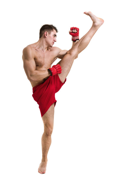 Full length portrait of young male boxer showing some movements against isolated white background - Foto, imagen