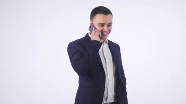 Portrait Of Happy Young Man Talking On Cell Phone Isolated On White Background - Metraje, vídeo