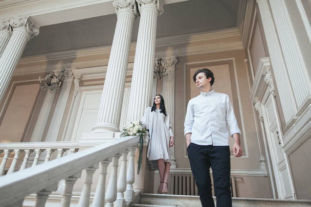 couple on staircase of majestic palace - Foto, imagen