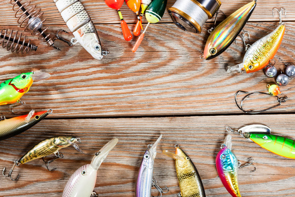Fishing accessories on a wooden background. - Фото, изображение