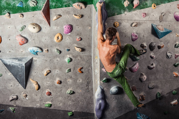 man exercise bouldering and climbing indoor - Fotoğraf, Görsel
