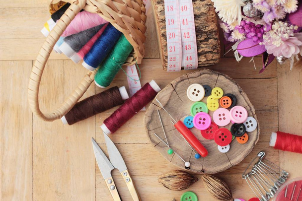 Sewing accessories for sewing on wood background - Foto, Imagen