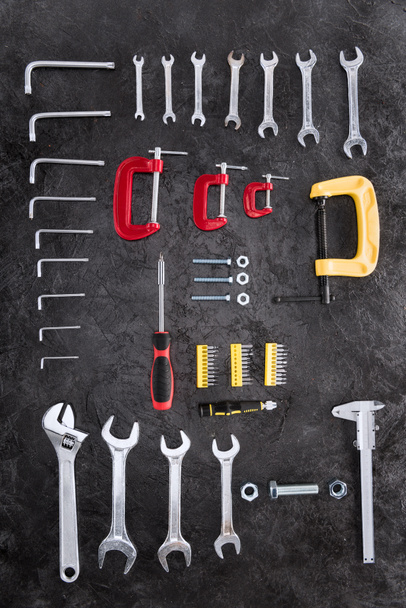 Top view of set of different construction tools on black  - Photo, Image