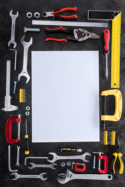 top view of set of various work tools and blank paper on black - Photo, Image