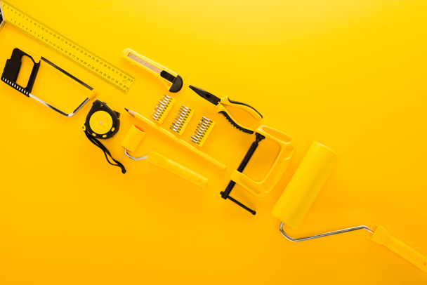 top view of various work tools and ruler on yellow  - Photo, Image