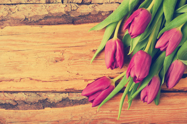 Bouquet of tulips on vintage wooden table - Foto, Imagen