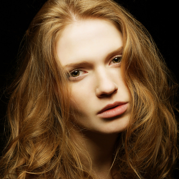 Emotive portrait of young beautiful ginger girl on black backgro - Foto, immagini