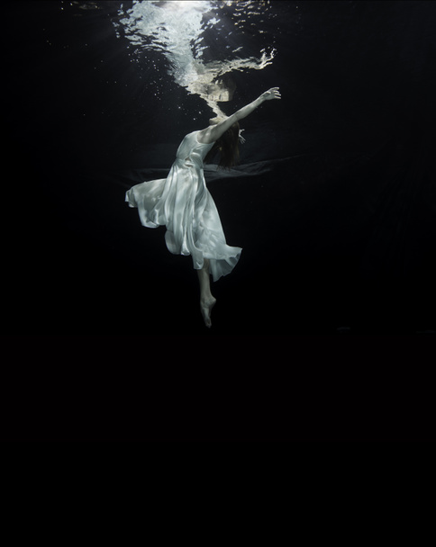 A young ballerina is dancing underwater - Фото, зображення
