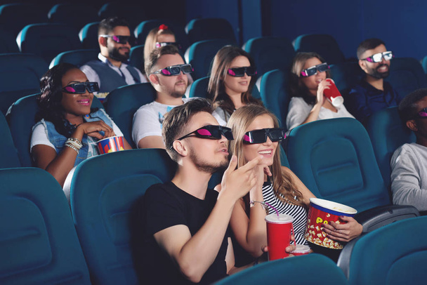 Boyfriend and gifriend watching  movie in cinema and emotionaly gesturing. - Foto, Imagem