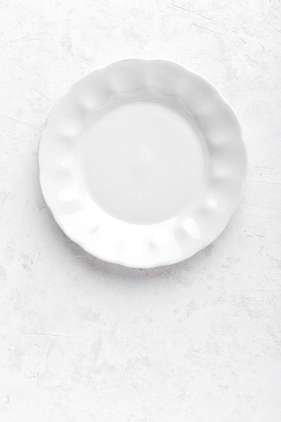 Empty white plate on white background top view copy space - Fotografie, Obrázek