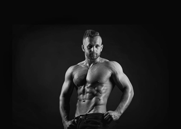 Attractive sporty handsome sexy muscular young adult male fitness model in black and white portrait - Photo, Image