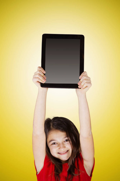 Happy smiling little girl holding tablet - Zdjęcie, obraz