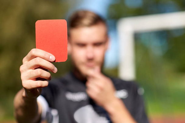 referee hands with red card on football field - Φωτογραφία, εικόνα