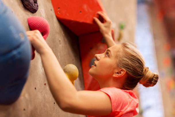 young woman exercising at indoor climbing gym - Foto, imagen
