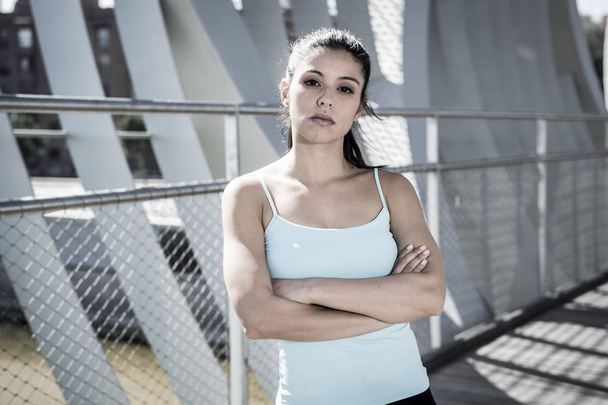 attractive hispanic brunette woman looking cool and defiant after running workout - Photo, Image