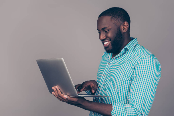 Portrait of happy afroamerican man using laptop comruter and che - Fotó, kép