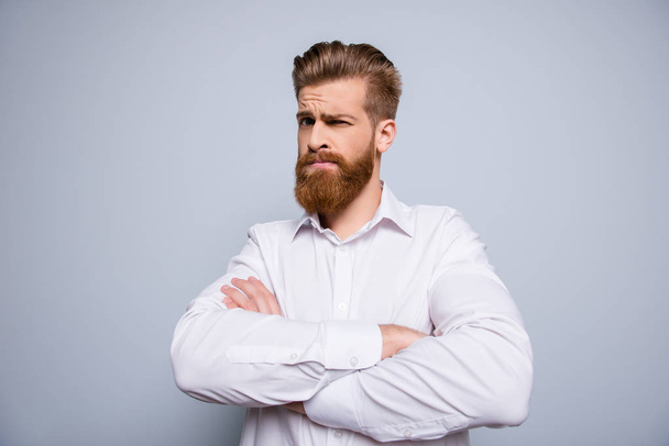 Portrait of serious confident bearded man keeping  crossed hands - 写真・画像