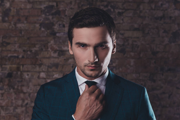 Portrait of confident young businessman in formalwear corecting  - Zdjęcie, obraz